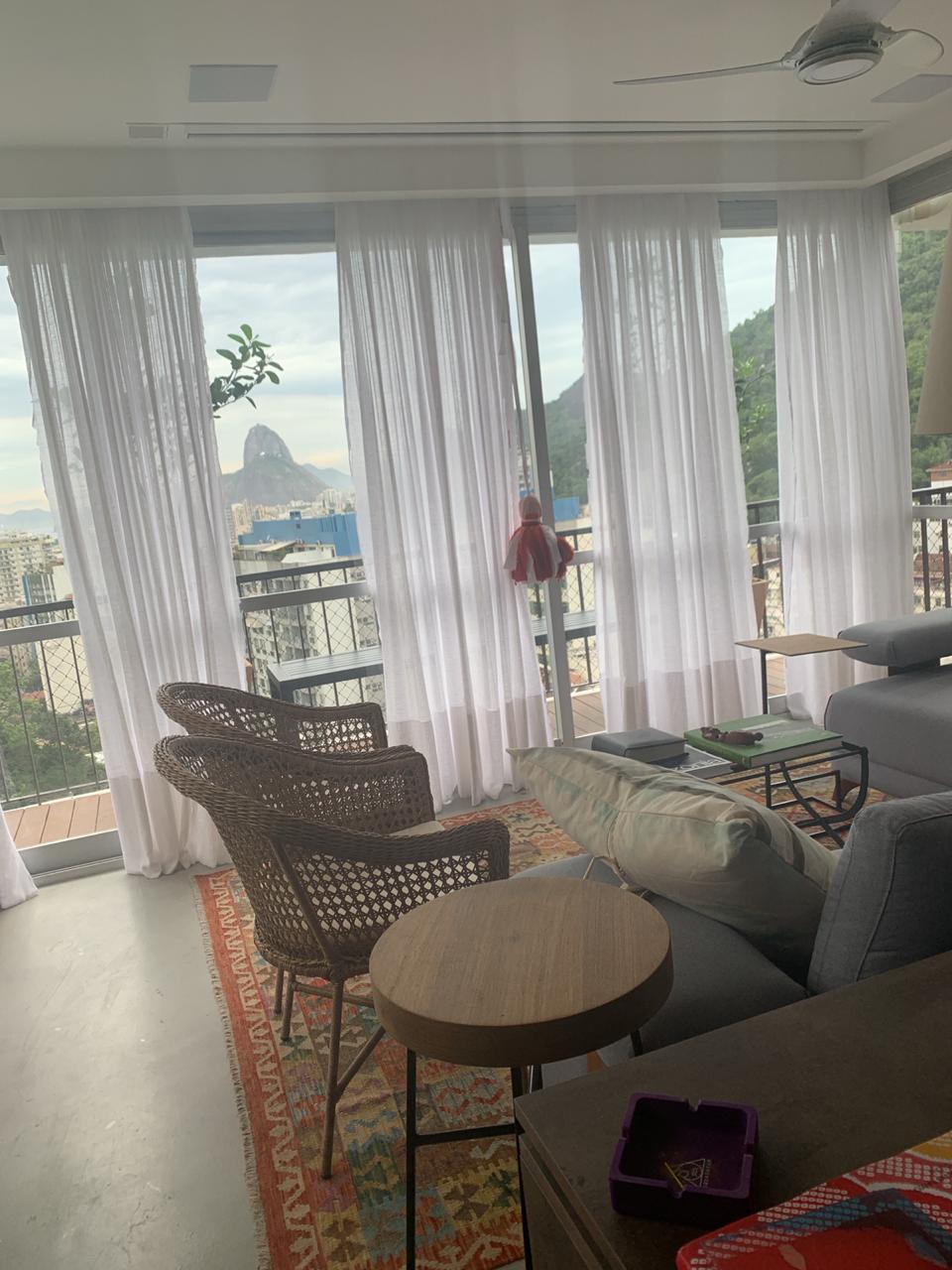 Sala reformada pela Congil com cortinas e vista para o Pão de Açúcar